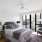 oversized windows in bedroom with ceiling fan